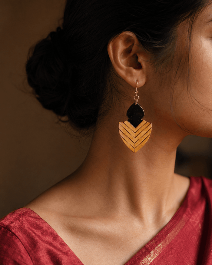 Varmini wooden earrings — a Boxwood shield inlaid with Ebony chevrons below an Ebony finial