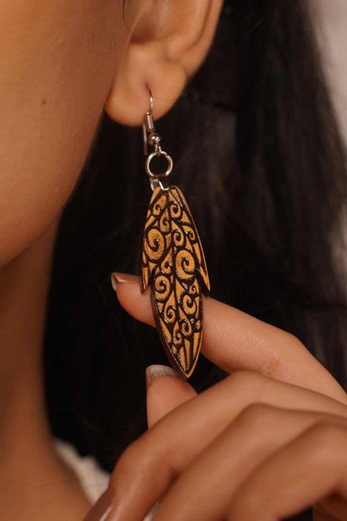 Kalpataru wooden earrings worn — engraved Boxwood leaf with dark filled vine-work