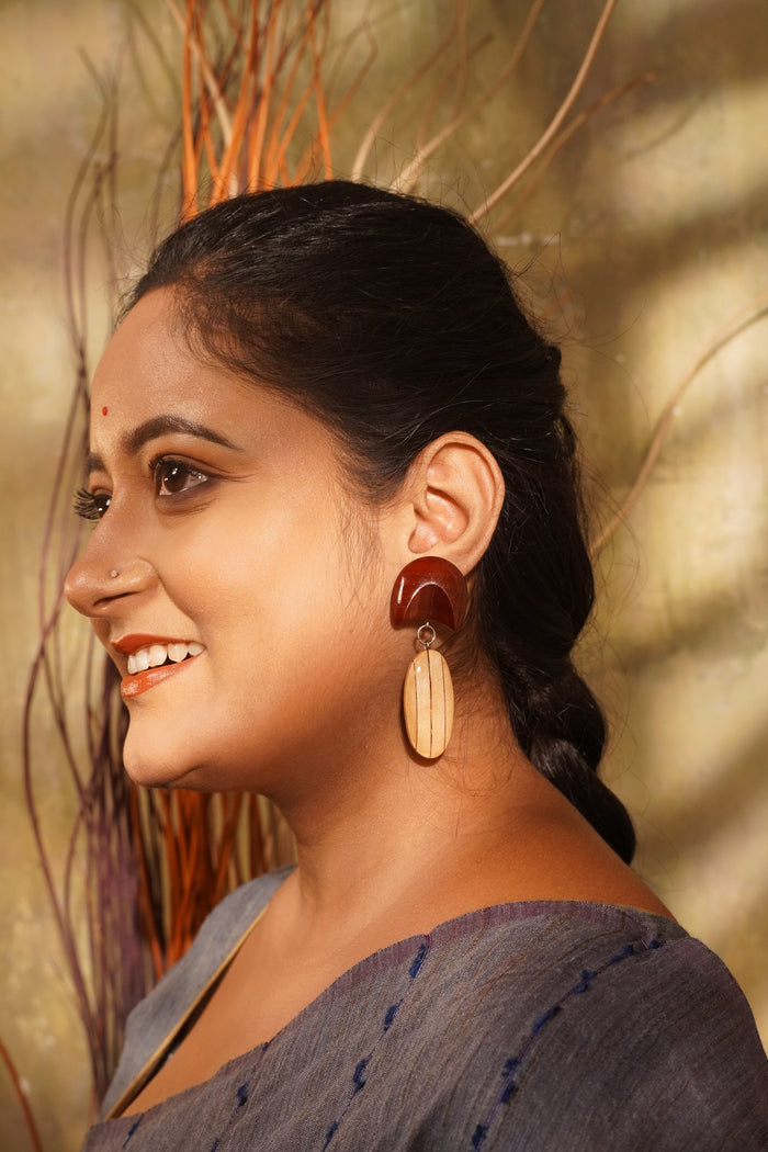 Chandrima wooden earrings worn with a grey saree — Padauk crescent above a Maple oval