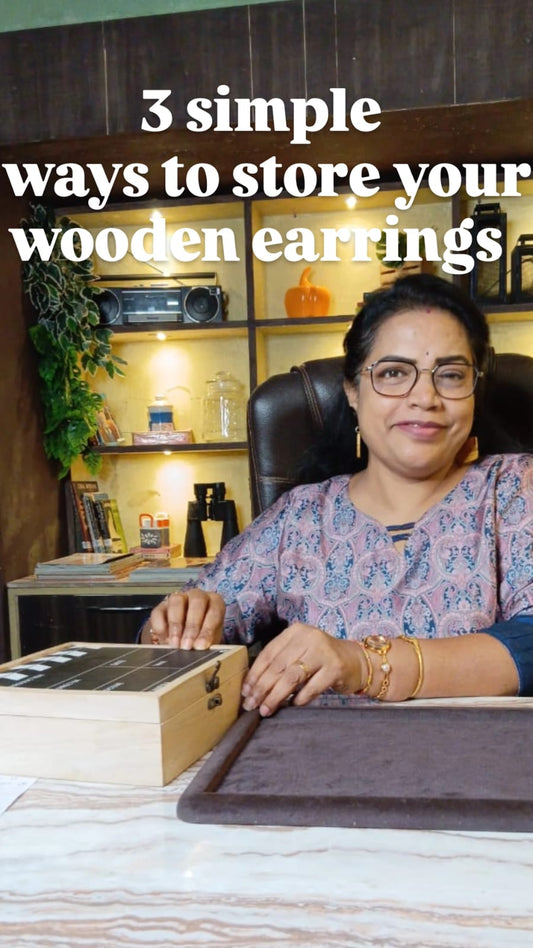 Handcrafted wooden earrings stored in soft cotton pouches inside a wooden box