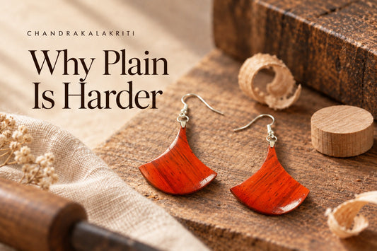 Plain Padauk fan earrings on a workbench with wood shavings and offcuts