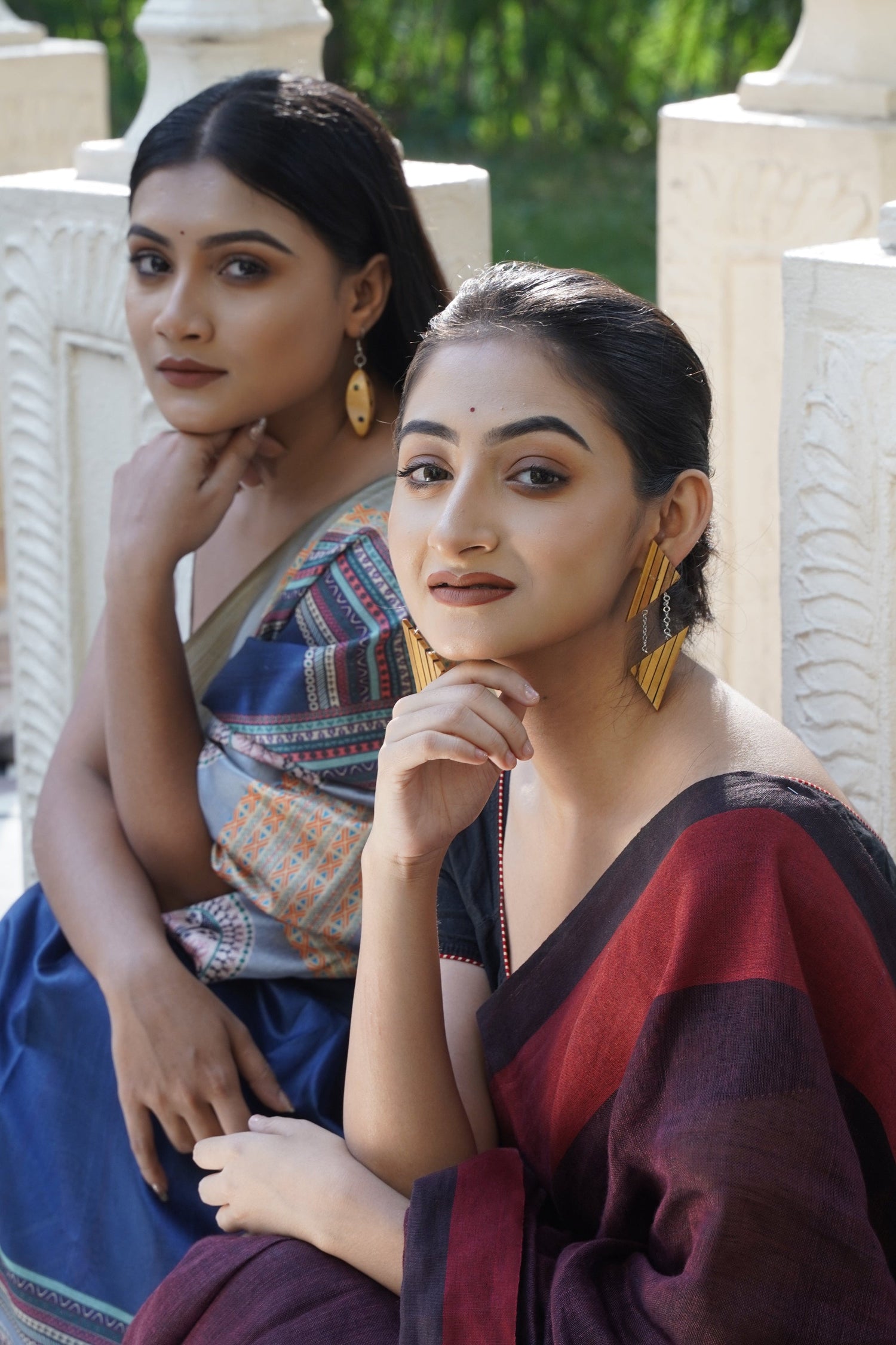 A collection of handcrafted wooden earrings, including dangle, drop and stud styles, all made with eco-friendly materials by Chandrakalakriti