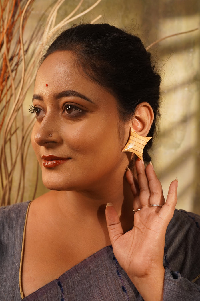 Model wearing Hanshika wooden earrings — Maple star studs inlaid with Ebony lines