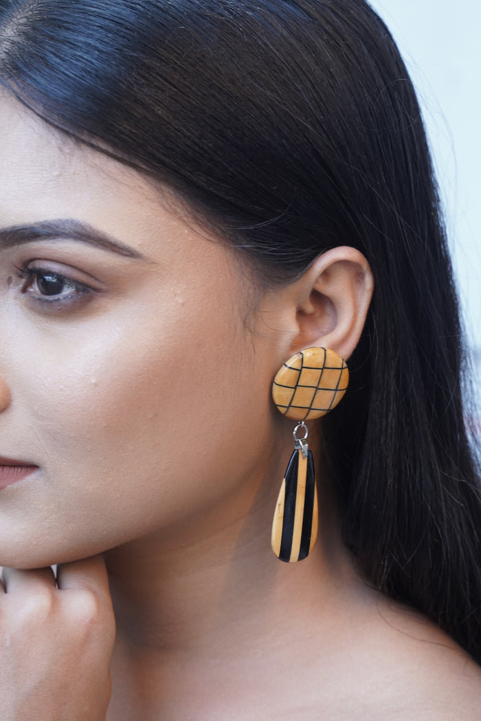 Aadhya wooden earrings worn — Ebony inlay lattice disc above a striped Boxwood teardrop