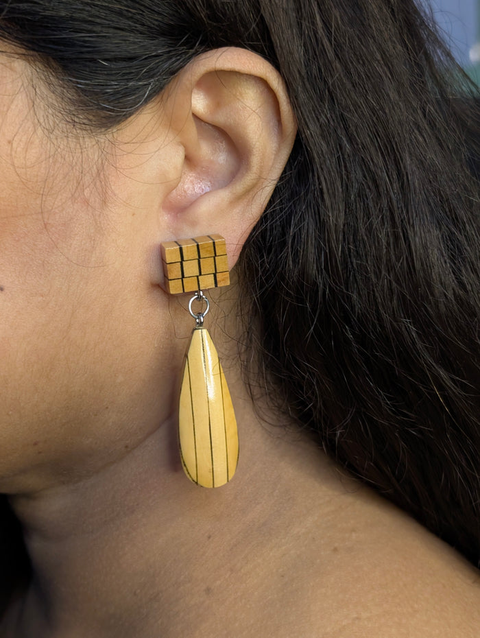 Kavya wooden earrings worn — joined Boxwood cube panel above an Ebony inlay teardrop