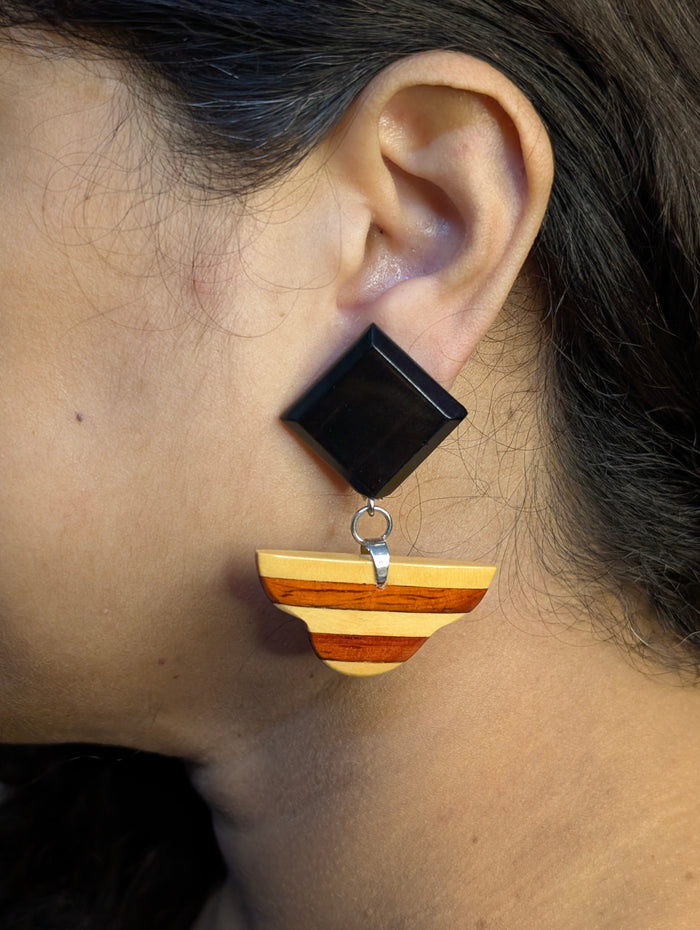 Rukmani wooden earrings worn — plain Ebony square above a Padauk and Boxwood banded drop