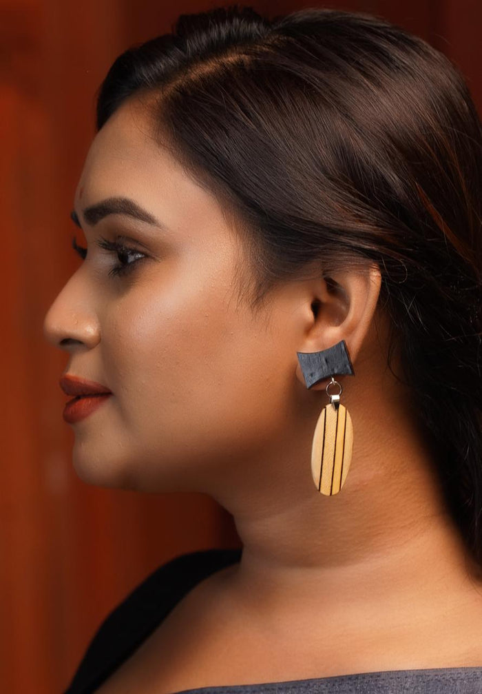 Amaya wooden earrings — Ebony bow above a Maple teardrop inlaid with fine Ebony lines
