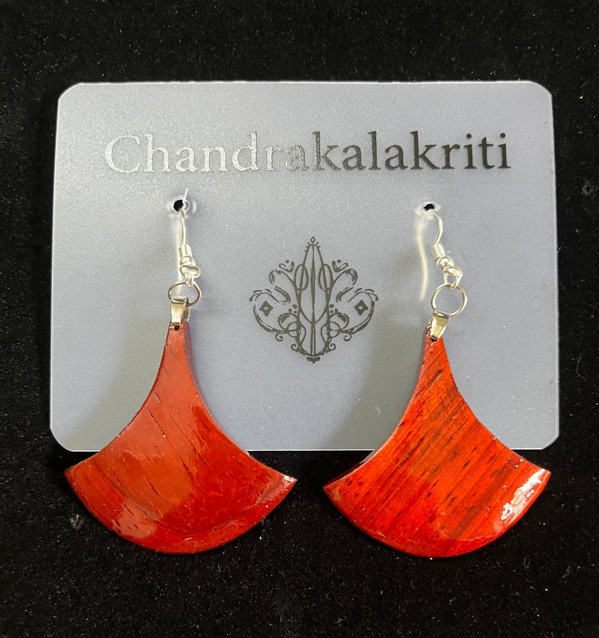 Aruna wooden earrings — Padauk fan drop earrings on a Chandrakalakriti card