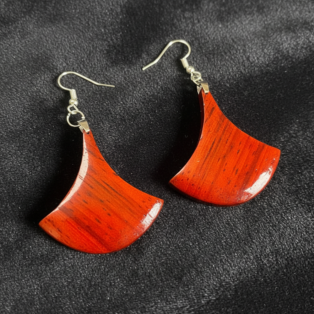 Pair of Aruna Padauk fan earrings showing the natural red grain and dark streaking